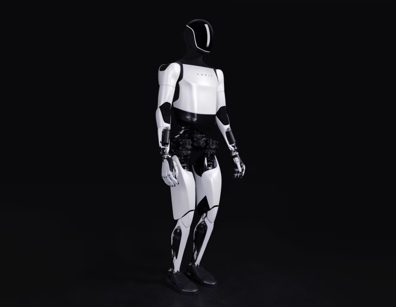 A white-and-black humanoid robot in three-quarter view with a dark face panel and 'TESLA' on the chest, on a dark background.