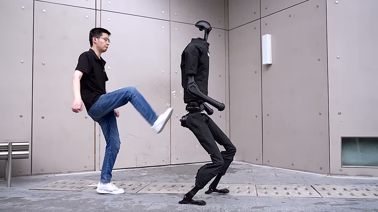 Unitree H1 humanoid robot demonstrating balance against a push outdoors. Still from the official Unitree video "Introducing Unitree H1" (2023).